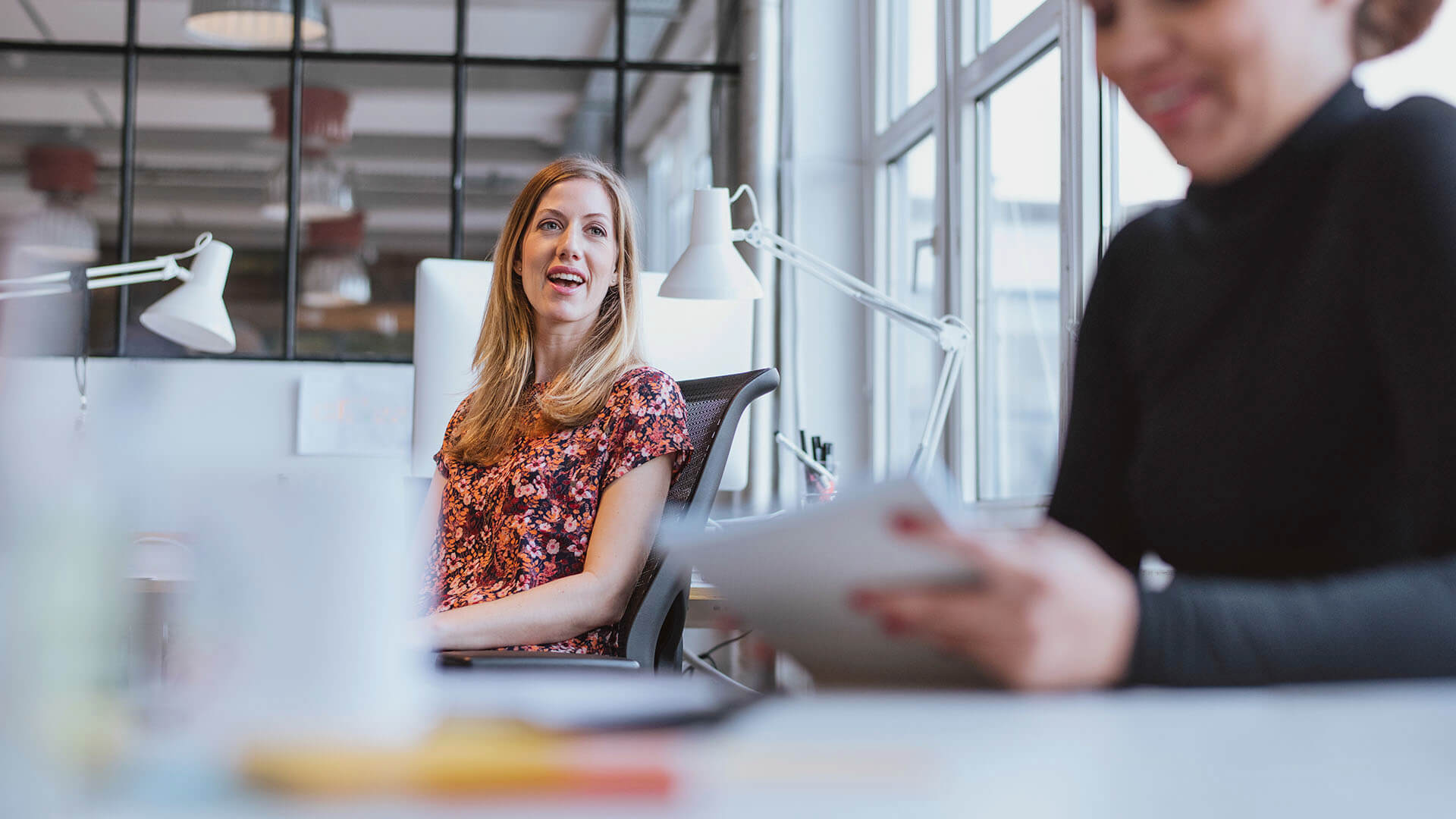 women chatting in office